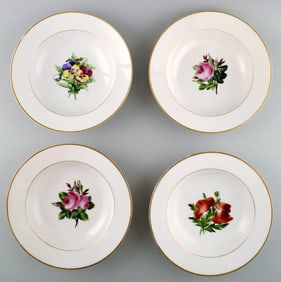 4 antique Royal Copenhagen deep plates in flora danica style.