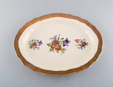 Royal Copenhagen serving dish in porcelain with floral motifs and gold border. Mid 20th century.