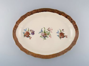 Royal Copenhagen serving dish in porcelain with floral motifs and gold border. Mid 20th century.