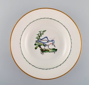 Royal Copenhagen soup plate in hand-painted porcelain with bird motifs and gold decoration. Early