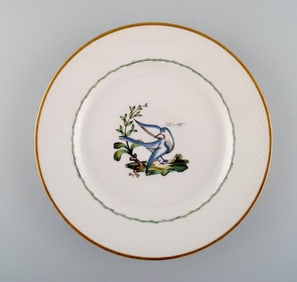 Royal Copenhagen dinner plate in hand-painted porcelain with bird motifs and gold decoration. Early