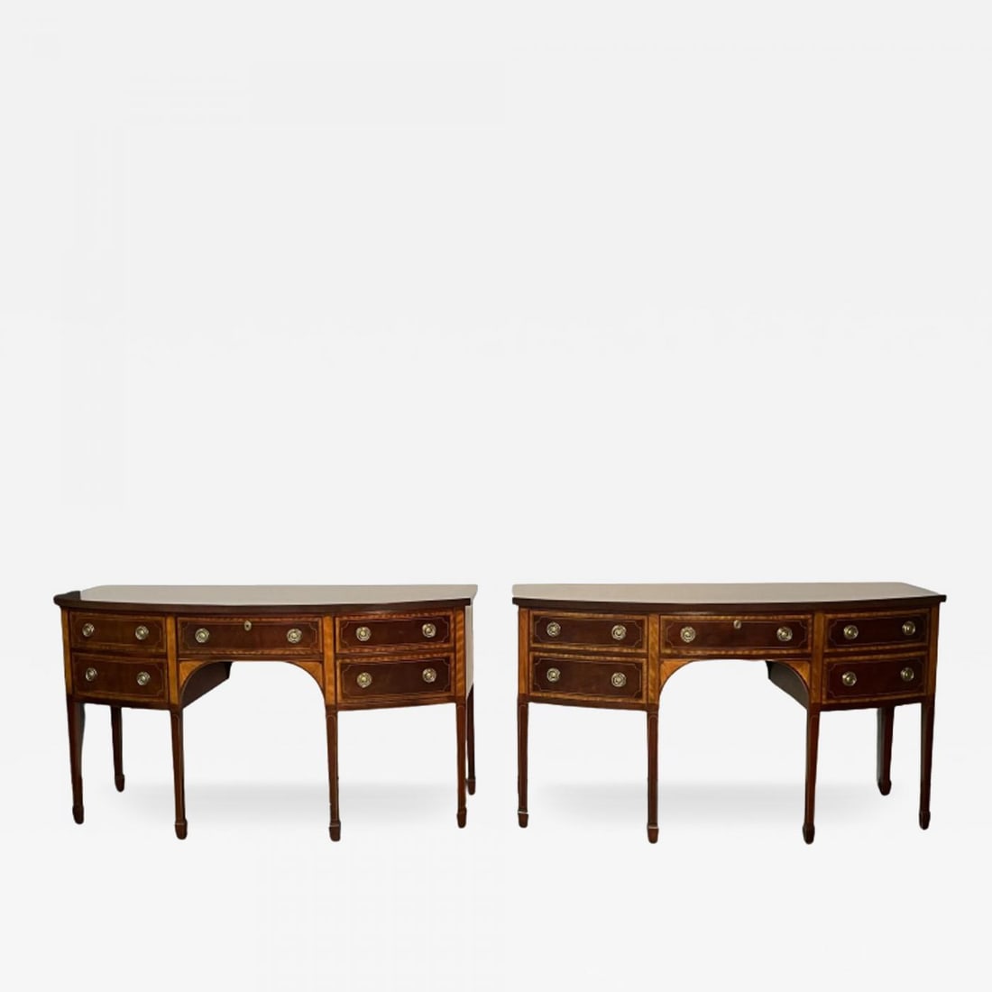 Pair of Baker Mahogany Satinwood Sideboards, Historic Charleston, Bow Front: Baker Mahogany Satinwood Sideboards or Credenzas, 'Historic Charleston Collection', Bow Front Fine condition. Pair of fully refinished Baker Furniture Console Tables featuring inlaid wood and classica