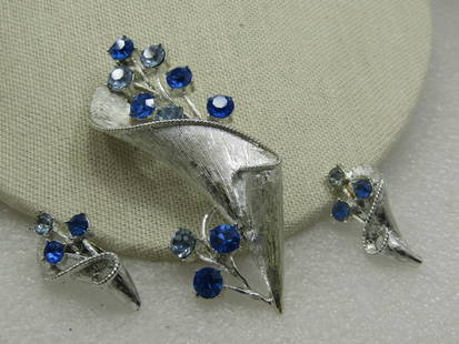 Vintage Coro Blue Rhinestone Modern Floral Brooch & Earrings , 1960's: Vintage Coro Blue Rhinestone Modern Floral Brooch & Earrings , 1960's. This has a textures wrapped design around a stem of light blue and dark blue rhinestone branch or blossoms to the side and coming