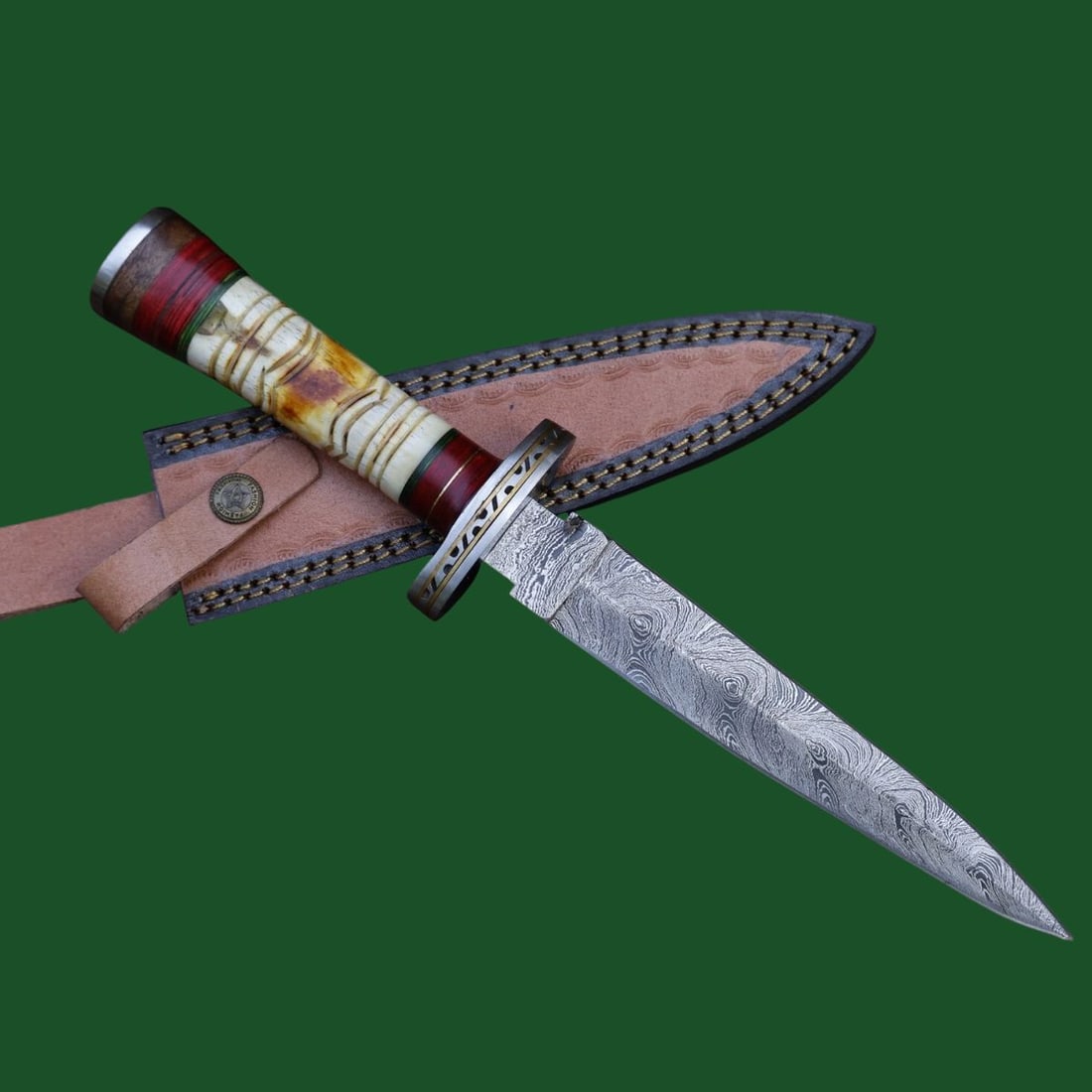 Damascus Dagger Knife Etched Bone Wood Handle: Title: Damascus Dagger Knife Etched Bone Wood Handle Description:This is a dagger knife with a wavy patterned Damascus steel blade. The handle is made of engraved bone and hardwood, with areas of ligh