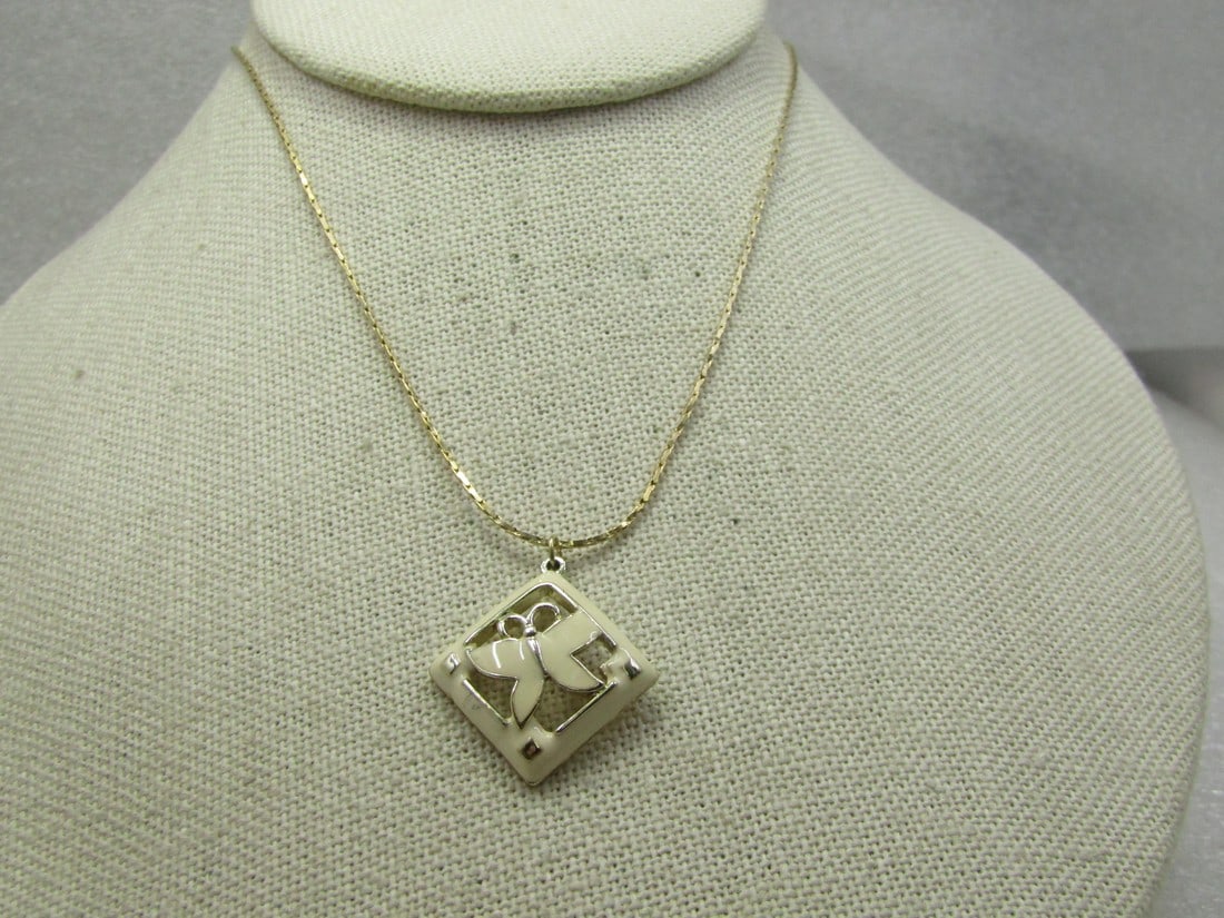 Vintage Whtie Enameled Butterfly Necklace, 18": Vintage Whtie Enameled Butterfly Necklace, 18". The chain is an appx. 1mm Boston ink with spring clasp and is slightly more yellow gold tone than the pendant which can look silver and gold tone. The t
