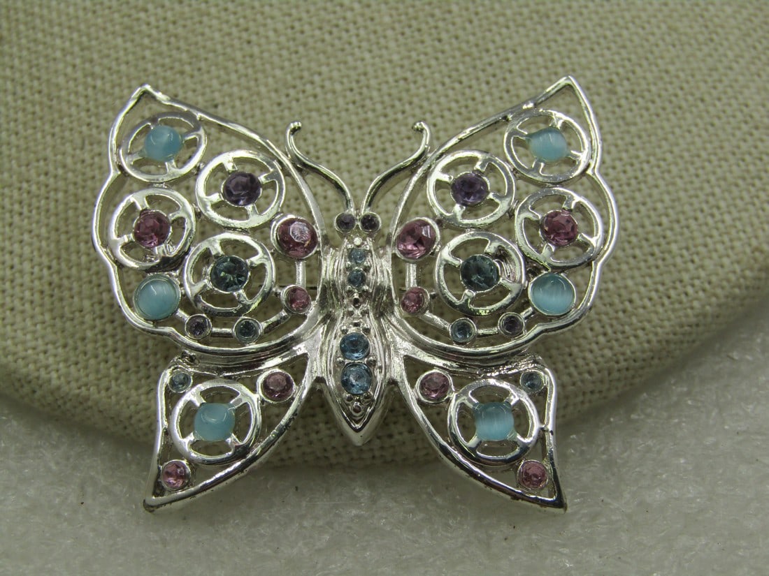 Vintage Rhinestone Moonstone Butterfly Brooch, Silver Tone: Vintage Rhinestone Moonstone Butterfly Brooch, Silver Tone with open design with pastel gemtone rhienstones and pale blue moonstoneos. 1.75" wide and 1-5/8" tall. Very good condition. Not signed by th