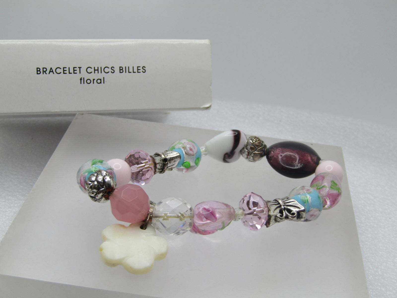 Glass Floral Beaded Bracelet, Butterfly Beads, Avon Chics Billes, Original Box 2010: Glass Floral Beaded Bracelet, Butterfly Beads, Avon Chics Billes, Original Box 2010. This has rose glass beads with blue centers and pink center with two butterfly beads, two rose beads, a rose glass
