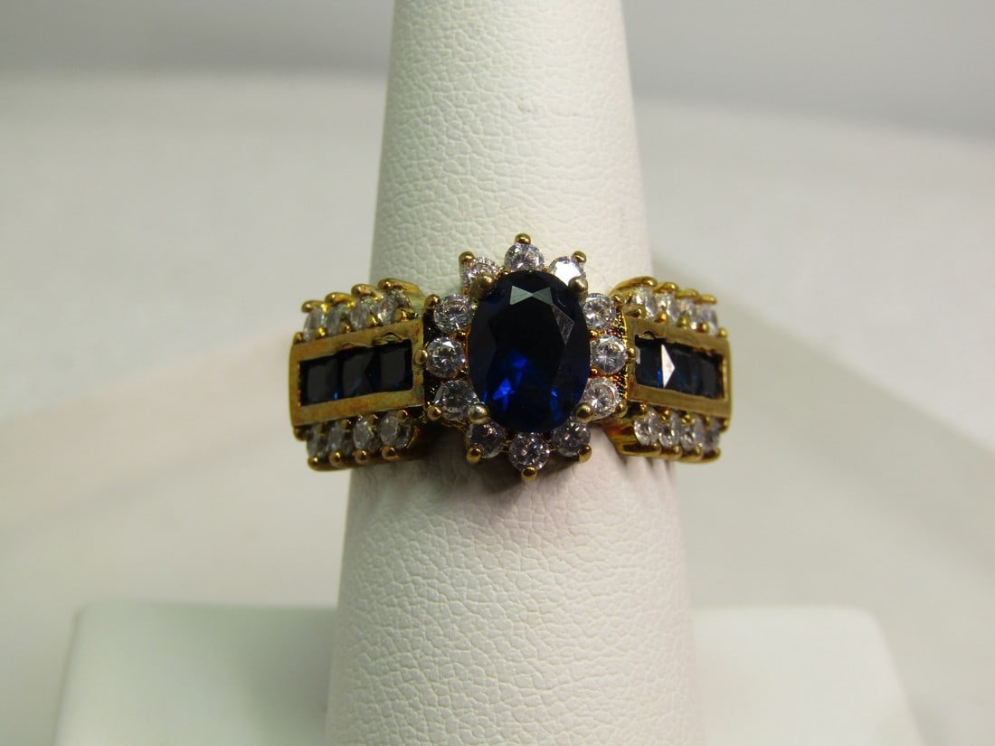 Vintage Blue & Clear Crystal Ring, Sz. 7.25 Mared .925, Gold Over, 1980's-1990's: Vintage Blue & Clear Crystal Ring, Sz. 7.25 Mared .925, Gold Over, 1980's-1990's. This has a main stone that is a deep sapphire blue in color, crystal or glass stone that is appx. 7.5mm by 5.5mm oval 