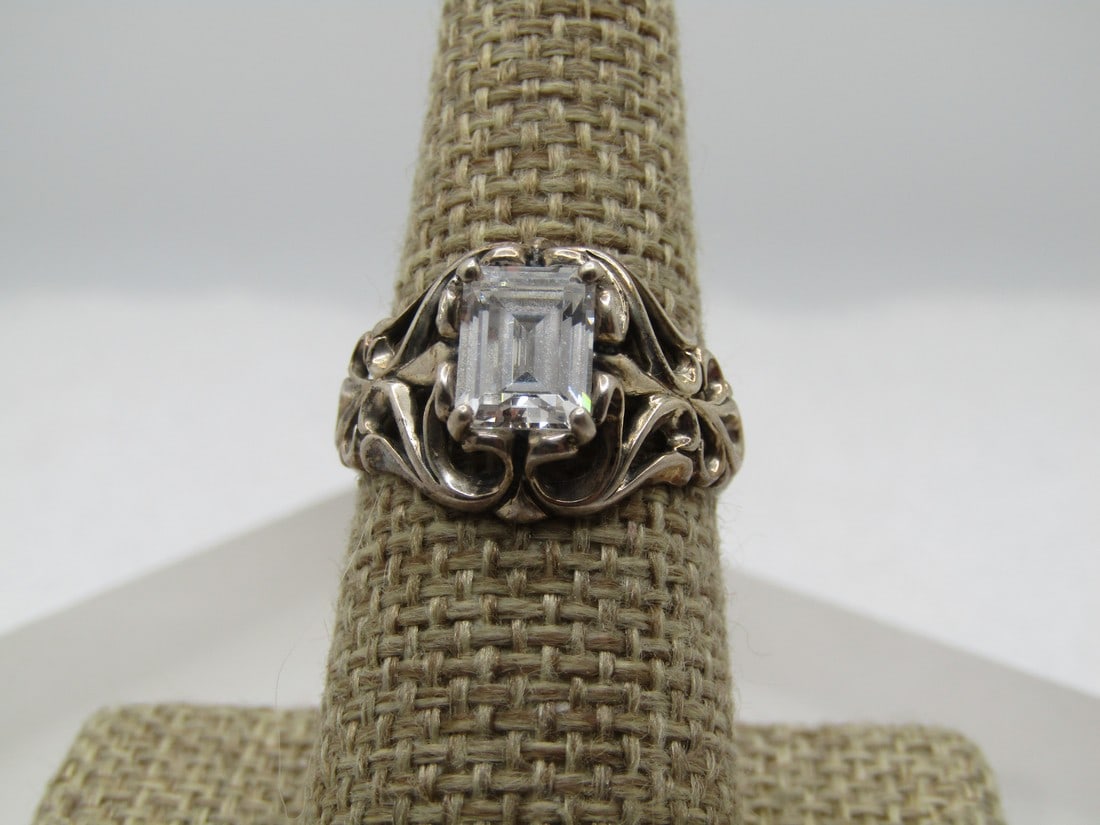 Sterling Clear Stone Ring, Sz. 8.5 Signed DQ and JB, 2000's: Sterling Clear Stone Ring, Sz. 8.5 Signed DQ abd KB. Age is 2000 or after. Diamonique. The stone is either CZ or crystal/glass. it is rectangular and set with prongs in the corner with a measurement o
