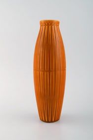Bo fajans, Sweden. Vase in glazed ceramics with ribbed body. Beautiful glaze in dark orange shades.