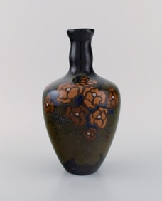 Arnhem, Holland. Antique art nouveau vase in glazed ceramics with hand-painted flowers and foliage.