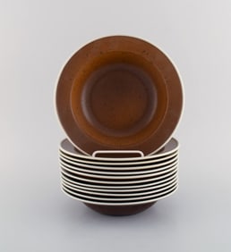 Stig Lindberg for Gustavsberg. Twelve Coq deep plates. Beautiful glaze in brown shades. Swedish
