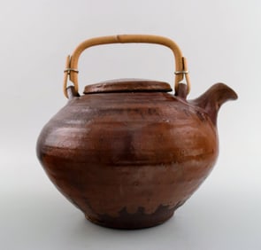 Gutte Eriksen own workshop, tea pot in ceramics. Handle in wicker. Stamped: Gutte.