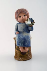 Lisa Larson for Gustavsberg. Rare stoneware figure. Girl with flowers.