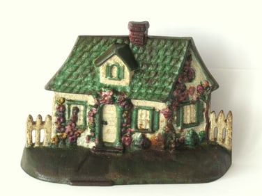 Antique cast iron cottage doorstop.