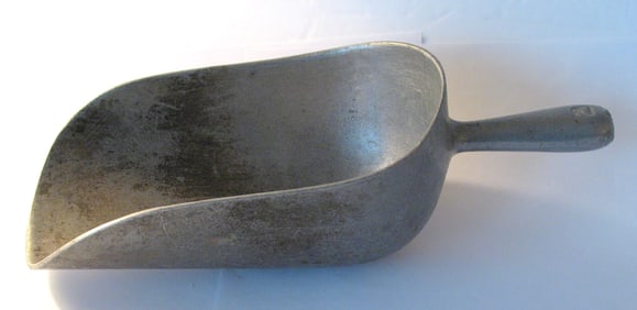 Vintage cast metal feed or grain scoop.