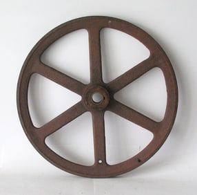 Antique cast iron industrial machinery pulley.