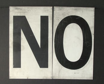 Antique tin movie marque letters “NO”.