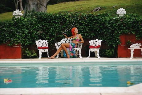 Slim Aarons 'Lounging In Bermuda' 1969 Oversize Unframed C Type Print: Description Slim Aarons 'Lounging In Bermuda' 1969 Oversize Unframed c type print A woman relaxes with a drink by a swimming pool in Bermuda, November 1969. (Photo by Slim Aarons) Unframed C Type