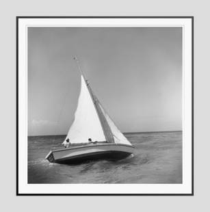 Slim Aarons 'Jamaica Sea Sailing' 1953 Oversize Black Frame Silver Gelatine Resin Print: Description Slim Aarons 'Jamaica Sea Sailing' 1953 Oversize Black Frame Silver Gelatine Resin Print Two men sailing their yacht ‘Eel II’ in Jamaica. (Photo by Slim Aarons) Black Frame