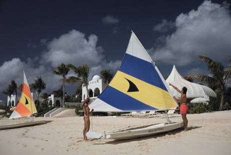 Sailing In Anguilla ' By Slim Aarons Oversized C Type: Description ' Sailing In Anguilla ' by Slim Aarons A couple adjusting the sail on their dinghy at a luxury resort on the island of Anguilla in the West Indies, January 1992. (Photo by Slim