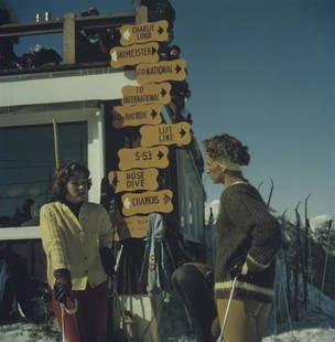 Slim Aarons 'Skiing In Stowe' 1962 C Type Print Framed In White: Description Slim Aarons 'Skiing In Stowe' 1962 C Type Print Framed In White Two women in knitwear, leaning on ski sticks, while standing in the Stowe Mountain ski resort in Stowe, Vermont, 1962.