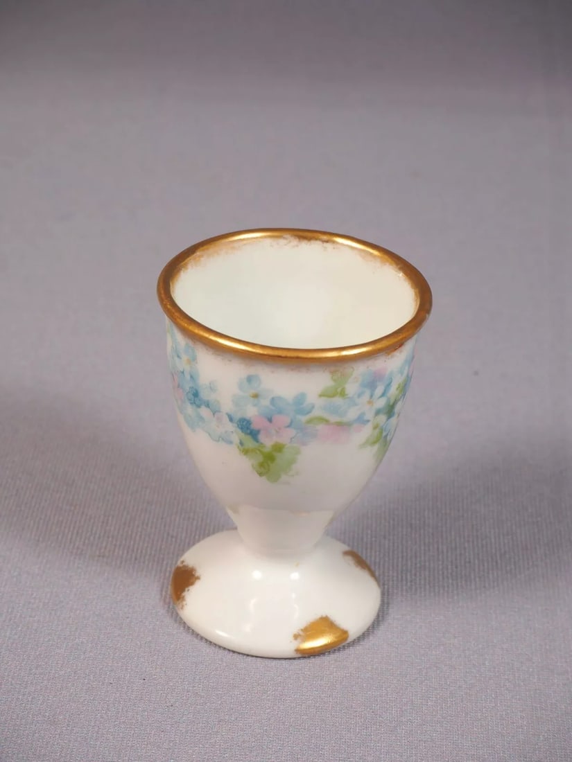 Limoges France Blue CHField Haviland GDA EGG CUP CHF189: This is rare and hard to find EGG Cup. The cup was made in Limoges, France by GDA Haviland . The pattern features blue flowers probably forget-me-not. It has a gold rim. The egg cup is 1 5/8" in diame