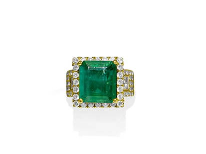 Contemporary 7.50 Carat Diamond Emerald Ring.: 14K Yellow gold. 5.50 carat emerald, 100% natural earth mined emerald. 2.00 carat diamonds, VS clarity and F color. Round brilliant cut and princess cut diamonds. All stones 100% natural earth mined