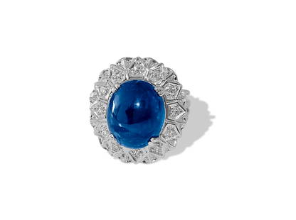 6.90 Carat Blue & Diamond Ring in 18K Gold. VINTAGE: Metal: 18K white gold. Diamonds: 0.40 carats total. Round brilliant cut. G color and VS clarity. Blue Sapphire: 6.50 carats. Cabochon cut blue sapphire set in prongs. All precious stones are 100% natu