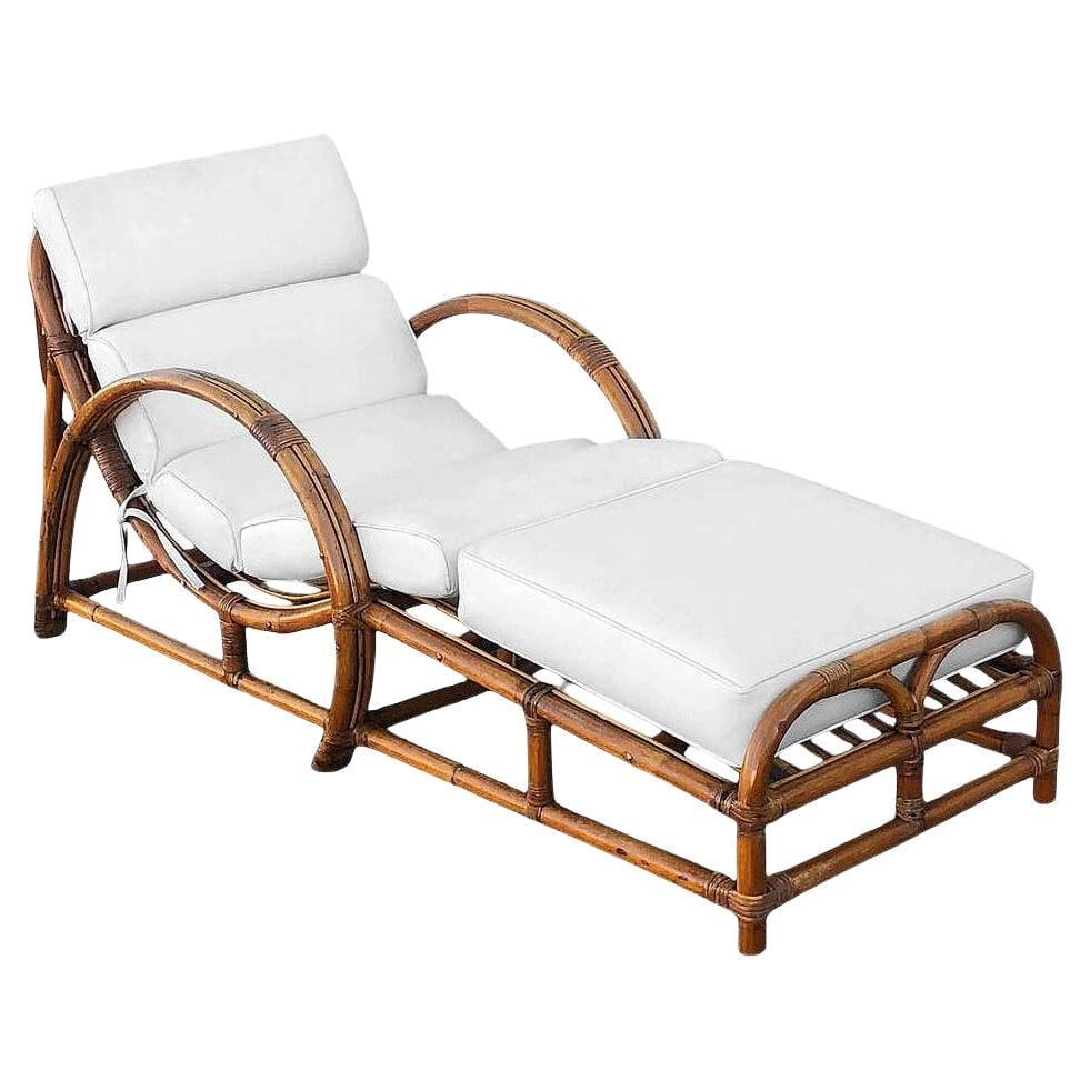 Restored Two-Strand "Half Moon" Rattan Cup Seat Chaise Lounge: About the Item This beautifully restored Paul Frankl-inspired Mid-century Era two-strand "Half Moon" rattan lounge chair with slop cup seat. This chair features a 2 strand loop arm with fancy wicker w
