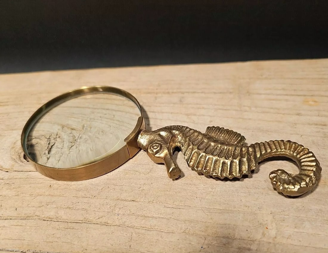 7" Brass Seahorse Magnifying Glass Desk Hand Lens: The 7" long x 3" wide glass reproduction of an antique magnifying glass with a cast brass seahorse handle is a stunning piece that harks back to the 18th and 19th centuries. During this era, magnifyin