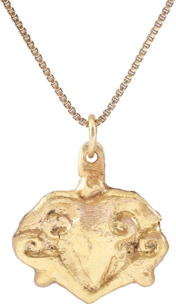 VIKING HEART PENDANT, 10TH-11TH CENTURY, DANELAW ENGLAND: Just over 3/4” (0.78”) height, made by the open-face mold technique. Gilt bronze of stylized form with cusped top, scroll sides with lower nubs and central trefoil. For Vikings, the heart 