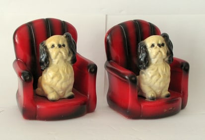 Vintage pottery dog in a red leather chair bookends.