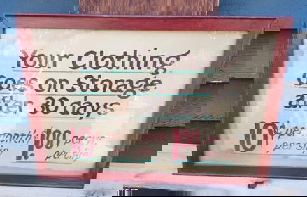 Hand Painted Clothing Sign 1930 laundry mat clothes go on storage after 30 days