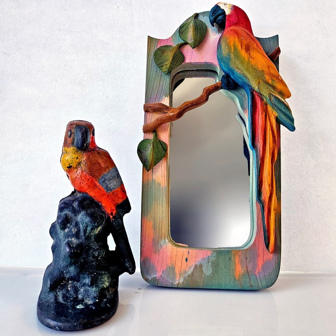 Parrots: Cast Iron Doorstop Bookend and Wood Carved Mirror (SIGNED): Title: Parrots: Cast Iron Doorstop Bookend and Wood Carved Mirror (SIGNED) Description: Parrot Mirror Wood Carving signed (Barbara) Sorenson 2001 Hand carved and hand painted wood 3D mirror. Measures