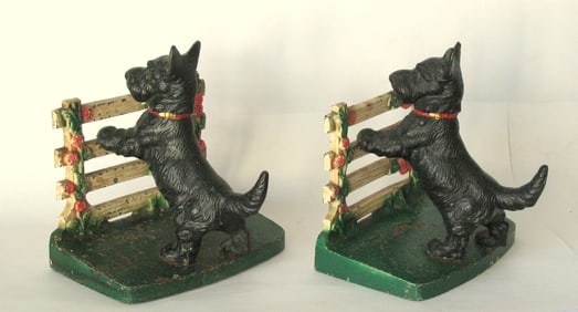 Antique cast iron Scotties by the fence bookends.
