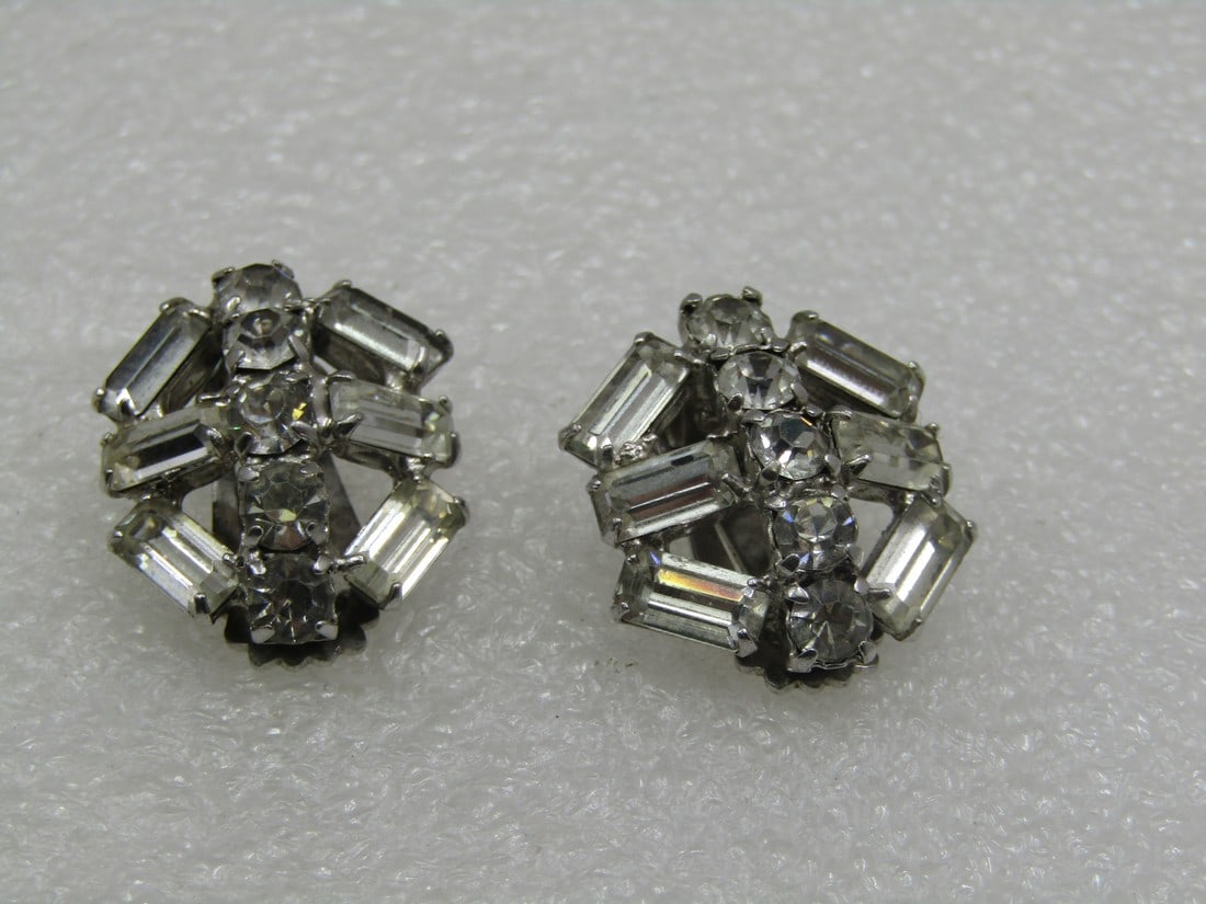 Vintage Rhinestone Art Deco Themed Clip Earrings, 1940's-1950's: Vintage Rhinestione Art Deco Themed Clip Earrings, 1940's-1950's. aPPX. 1" across. Silver tone setting with six large baguettes in each earrings and 5 round stones in each. The baguettes are appx. 8mm