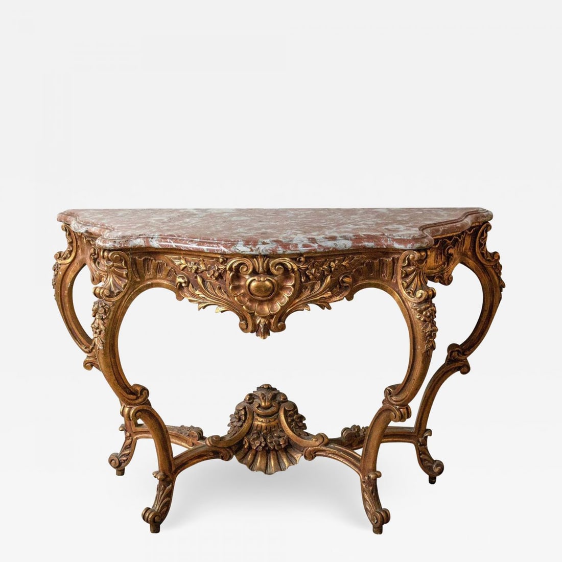 Marble-Top Louis XV Style Console Table by Jansen Exquisite Carved Details 1920s: Description: Marble-top Louis XV style console table by Jansen. This is a fine and early example of French design at its best. This Louis XV style console has a deep serpentine design leg with a lower