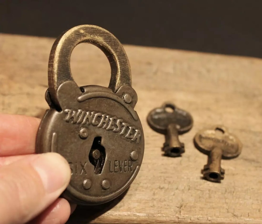 Cast Iron Winchester Firearms Ammo Box Padlock Lock & Key: 3" tall x 2" Wide the shank is 3/8" at its thickest Nice reproduction cast iron winchester padlock! This lock is fully functional! Hard to tell its age. Heavy iron and brass. Great aged patina through