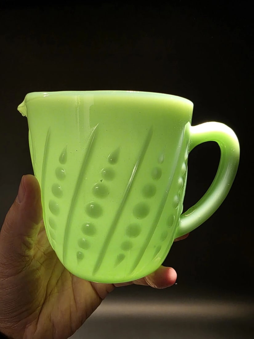 Jadeite Depression Glass Retro Beaded Milk Pitcher: Reproduction never used Jadeite beaded milk pitcher, a type of jade green opaque milk glass popular in the United States in the early to mid-20th century. This pitcher, produced by Anchor Hocking unde