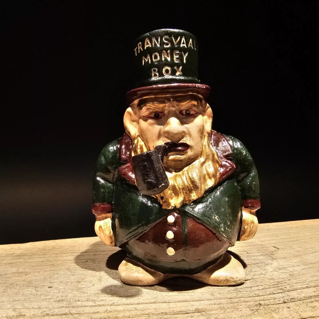 Cast Iron Transvaal Money Coin Bank: 5 1/2" Tall Great reproduction cast iron coin bank. All cast iron hand painted, slightly distressed as shown in the images. Certainly looks old! Reserve: $20.00 Shipping: Domestic: Flat-rate of $12.00