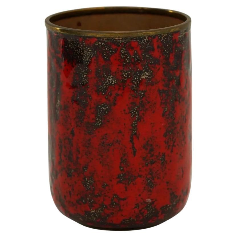 German Graflich Ortenburg Manner Fat Lava Glaze Cup: A West German Graflich Ortenburg manner glaze over brass cup. The ware is covered with lava glaze in a red shade. Unmarked. Circa: 1960s to 1970s. Graflich Ortenburg were founded in 1946 and based in