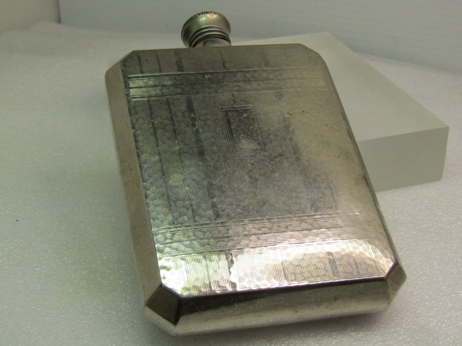 Vintage Textured Flask, Silver Tone, Stainless Steel, 5" by 3", 1950's-1970's: Vintage Textured Flask, Silver Tone, Stainless Steel, 5" by 3" and appx. 3/4" thick. Age is estimated at 1950's-1970's. It has a textured art deco style design on the front with a place for engraving