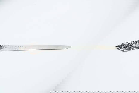 Silver letter opener with coat of arms of Portugal: Description: Silver letter opener with Portuguese coat of arms engraved on the blade. Metal: Silver. Origin: Portuguese. Brand: Javali II Title. Weight: 57.38 grams | 2.02 ounces. Dimensions: 22x0.5 c