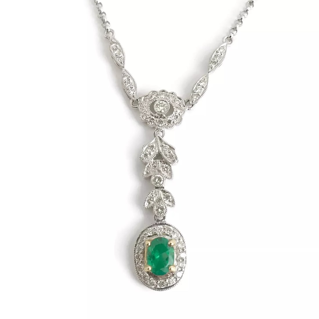 Green Emerald Diamond Halo Drop Pendant Lariat Y Necklace 18K White Gold .89 CTW: Green Emerald Diamond Halo Drop Pendant Lariat Y Necklace 18K White Gold .89 CTW Make a statement with this gorgeous necklace. Gemstone: 1 oval green emerald, .37 ct Diamonds: round brilliant cuts .52