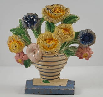 Antique Marigold Flowers Cast Iron Hubley Doorstop: Title: Antique Marigold Flowers Cast Iron Hubley DoorstopDimension: 7 ¾” tall x 8” wide.Date: Ca. 1930’s.Additional Information: Charming array of Marigolds in ribbed Vase cast