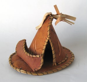 Vintage tourist souvenir Indian tepee with canoe.