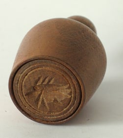 Antique miniature butter print with a carved fish design.