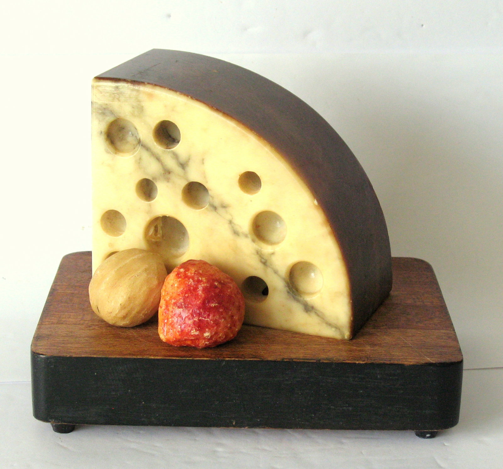 Antique stone wedge of Swiss cheese.: Title: Antique stone wedge of Swiss cheese. Date/Period: 1940's Dimension: 4 34” x 4” x 2 1/2” Additional Information: Nice antique stone wedge of Swiss cheese in original patina & c