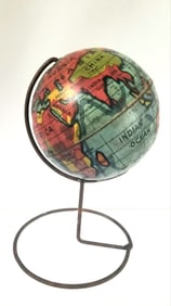 Cool little tin globe on a wire stand, it revolves